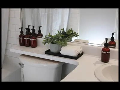 a bathroom with a toilet and a sink and a mirror at Bright Whistler Village Getaway w/ pool & hot tub in Whistler
