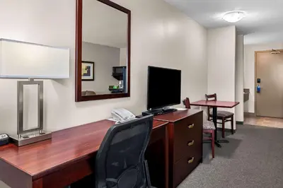 an office with a desk with a computer and a mirror at SureStay Hotel by Best Western Bassano in Bassano