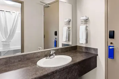 a bathroom with a sink and a mirror at SureStay Hotel by Best Western Bassano in Bassano