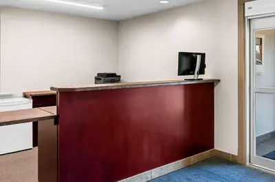 a room with a bar with a tv on the wall at SureStay Hotel by Best Western Bassano in Bassano