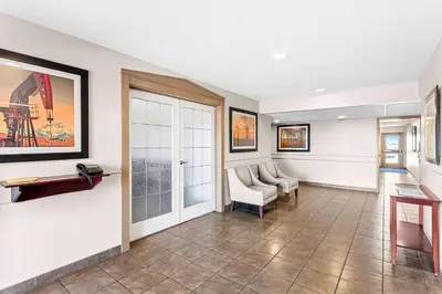 a waiting room with chairs and a table at SureStay Hotel by Best Western Bassano in Bassano