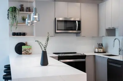 a white kitchen with a vase on the counter at Ghost Peak by Revelstoke Vacations in Revelstoke