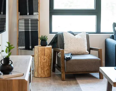 a living room with a chair and a table at Ghost Peak by Revelstoke Vacations in Revelstoke