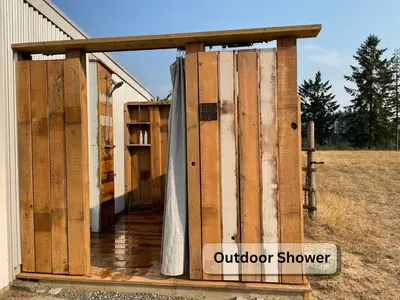 an open door to a outdoor shower on a house at Smith Lake Farm in Merville