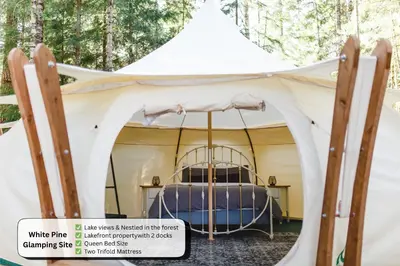 a bed in a white tent at Smith Lake Farm in Merville