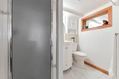a bathroom with a toilet and a mirror at Gulf Island View Suite by EMR Vacation Rentals in Chemainus