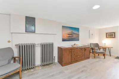 a living room with a radiator and a table and chairs at Gulf Island View Suite by EMR Vacation Rentals in Chemainus