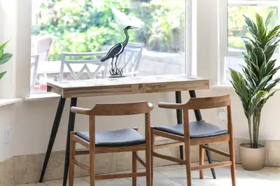 a table with two chairs and a bird statue on it at Gulf Island View Suite by EMR Vacation Rentals in Chemainus