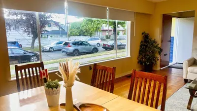 a dining room with a table and a view of a parking lot at Spacious home 15mins to Downtown in Vancouver