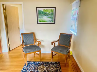 a hallway with two chairs and a rug at Spacious home 15mins to Downtown in Vancouver