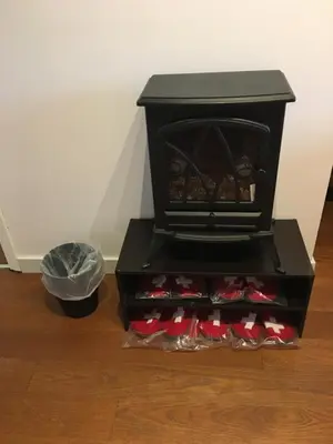 a black stove with red shoes in a room at The Blue Cottage B&B in Seventy Mile