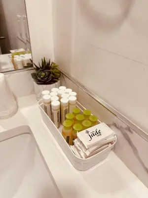 a bathroom counter with a tray with bottles of medicine at unit #203 Cozy Mountain View 1BR in DT in Canmore