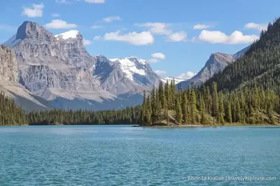 a view of a lake with mountains in the background at Luxurious Comfortable Suite in Airdrie