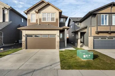 a house with a garage in front of it at Luxurious Comfortable Suite in Airdrie