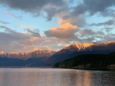 a view of a lake with mountains in the background at Earls Cove Orca View in Egmont