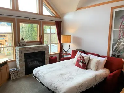 a living room with a couch and a fireplace at Glacier Lodge Steps to Trails and Nature in Whistler