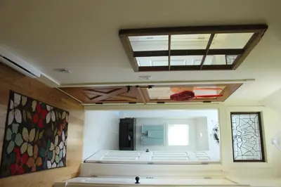 a room with a large mirror and a window at Thistle Dew Cottage in Ganges