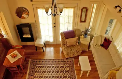 a living room with a couch and a table at Thistle Dew Cottage in Ganges