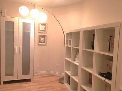 a room with a hallway with shelves and a lamp at Van Nest near YVR UBC Downtown in Vancouver