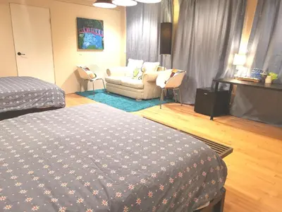 a bedroom with a bed and a living room with a couch at Van Nest near YVR UBC Downtown in Vancouver