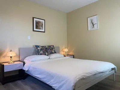 a bedroom with a white bed and two lamps at New Master room & private washroom 203 in Richmond