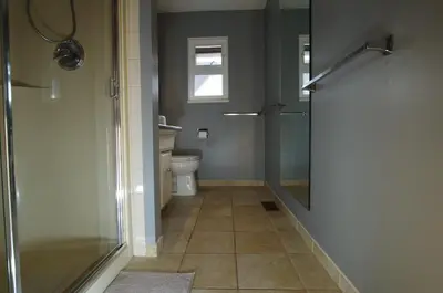 a bathroom with a shower and a toilet and a window at New Master room & private washroom 203 in Richmond