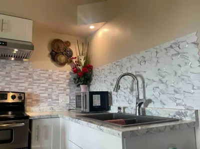a kitchen with a sink and a microwave at Four Seasons Private Villa in Powell River