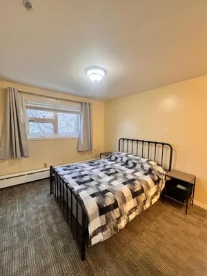 a bedroom with a bed and a window at Discovery Suite in Yellowknife