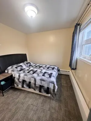 a bedroom with a bed and a window at Discovery Suite in Yellowknife