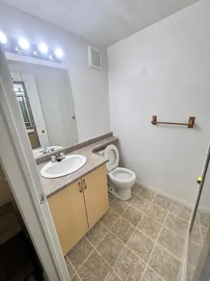 a bathroom with a sink and a toilet and a mirror at Discovery Suite in Yellowknife