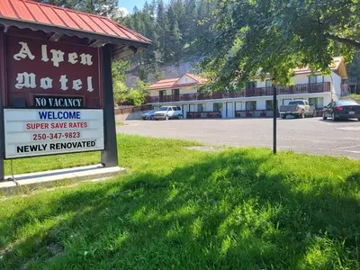 a sign for a new motel in a parking lot at Alpen Motel in Radium Hot Springs