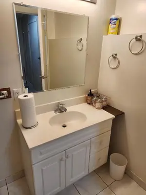 a bathroom with a sink and a mirror at Economical Homestay hostel in Burnaby
