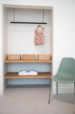a room with a shelf and a green chair at Cabot Views by Revelstoke Vacations in Revelstoke