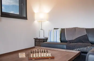 a living room with a chess board on a table at Stoke House by Revelstoke Vacations in Revelstoke