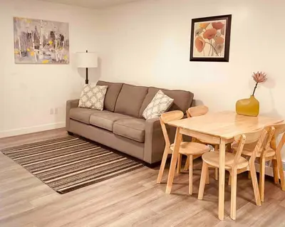 a living room with a couch and a table at Unit #201 Cozy Mountain View 1BR in DT in Canmore