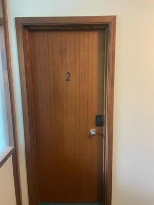 a wooden door with the number two on it at One Bedroom Main floor Apartment in Camrose