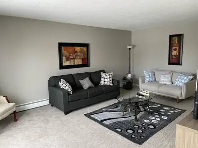 a living room with a couch and a table at Exquisite 2 Bedroom Apartment in Camrose