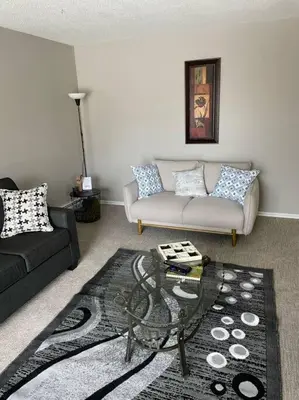 a living room with a couch and a table at Exquisite 2 Bedroom Apartment in Camrose