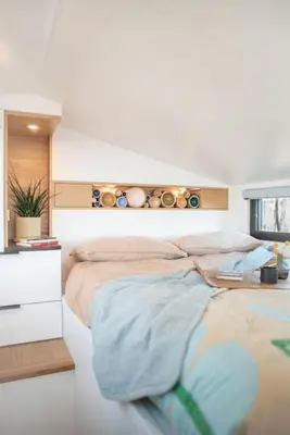 a bedroom with a large bed and a desk at Refuge Bay's Aqua Tiny Home - Luxury Off Grid Escape in Cherhill