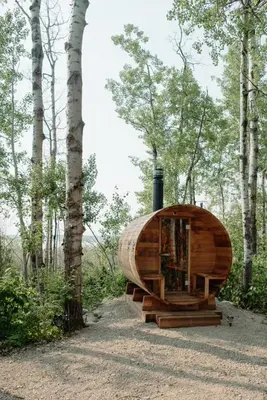 a wooden cabin in the middle of a forest at Refuge Bay's Aqua Tiny Home - Luxury Off Grid Escape in Cherhill