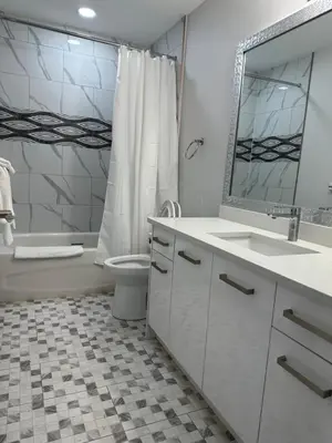 a bathroom with a sink and a toilet and a mirror at RAMSHORN MOTEL in Lumby