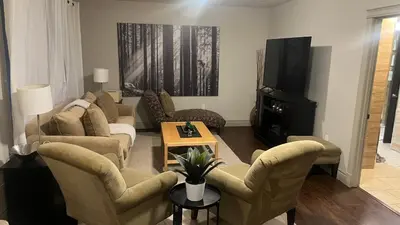 a living room with a couch and chairs and a television at Private Walkout Suite with a View in Calgary