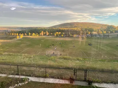 a group of people on a soccer field at Private Walkout Suite with a View in Calgary