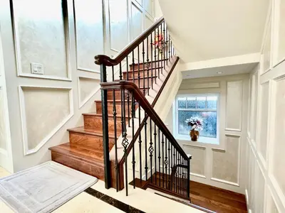 a spiral staircase in a home with wood floors at Vancouver Airport guesthouse in Vancouver