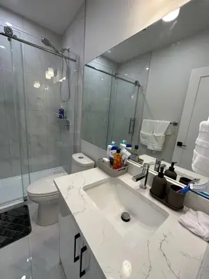 a bathroom with a sink and a shower and a toilet at 2 Bedroom 2 Washrooms Brand New Beautiful & Cozy Suite in Calgary