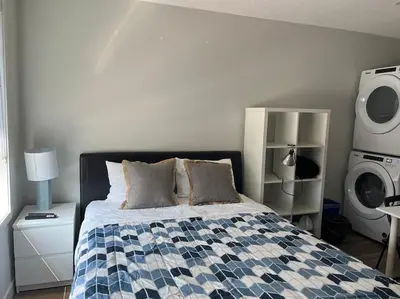 a bedroom with a bed with a blue and white quilt at Mountain View Studio in Town in Canmore