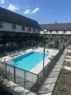 a swimming pool in front of a building at Mountain View Studio in Town in Canmore