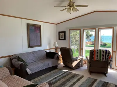 a living room with a couch and a chair at 4 Seasons Lakeview Cottage w/ Private Boating Dock in Westerose
