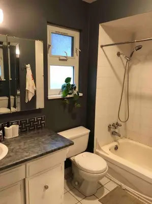 a bathroom with a toilet and a tub and a sink at private room with queen bed in richmond 202 in Richmond