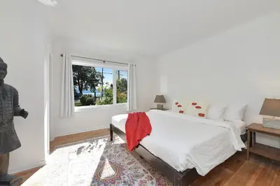 a bedroom with a bed and a window at The Bayside Cottage by EMR Vacation Rentals in North Saanich